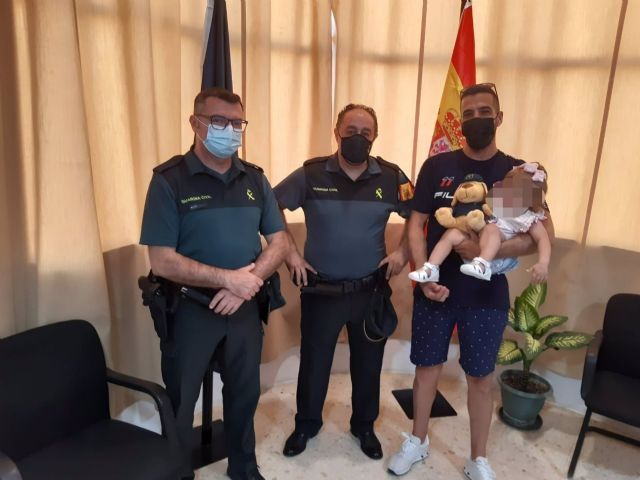 Agentes de la Guardia Civil, con la beb auxiliada cuando se ahogaba en una piscina en Mairena del Alcor, Sevilla