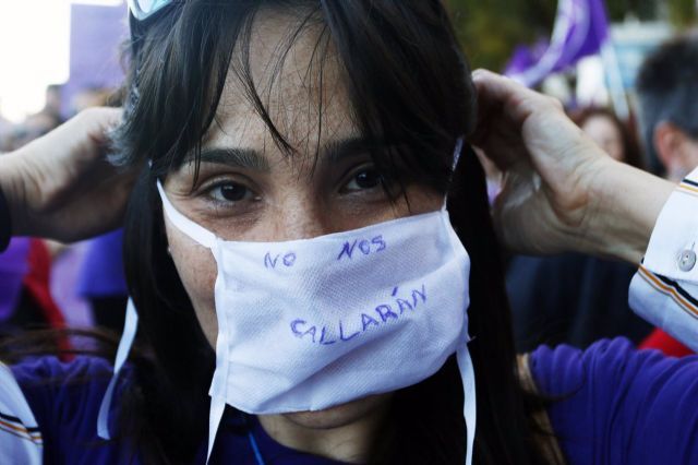 Una mujer se coloca una mascarilla en la que se lee No nos callarn durante la marcha por el Da Internacional de la Mujer en Mlaga, (Andaluca, Espaa), a 08 de marzo de 2020
